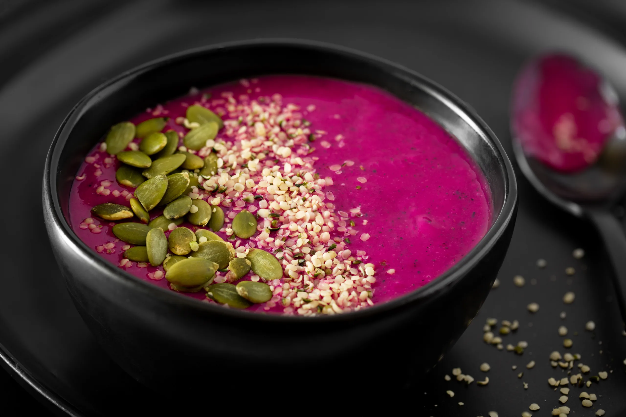 Healthy Raw Food Dragon Fruit Smoothie In A Black Bowl Topped With Pumpkin And Hemp Heart Seed